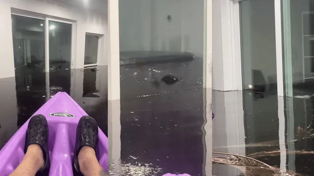 viral-video-shows-man-casually-kayaking-inside-water-submerged-house-amid-hurricane-aftermath-internet-reacts