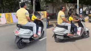 Viral Video Of Little Schoolgirl Driving Scooter With Her Father Sitting At Back Splits Internet | WATCH