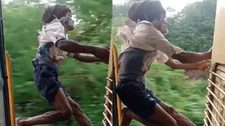Elderly Man Performs Life-Threatening Stunts Near Speeding Train’s Door; Internet Says ‘Cat With 9 Lives’ | Viral Video