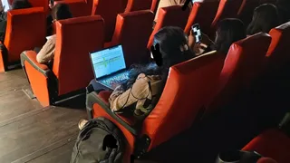 Bengaluru Woman Works On Laptop Inside Theatre While Watching Lokah; Viral Post Fuels Work Culture Debate