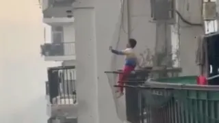 Ghaziabad: Child Sits On High-Rise Balcony Grill With Legs Dangling; Internet Demands Stricter Safety Measures | WATCH