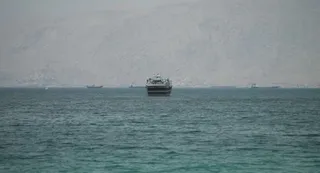 Hormuz Tensions Escalate Again After Suspected Iranian Strike On Vessel; UN Halts Escort Of Ships Through Strait