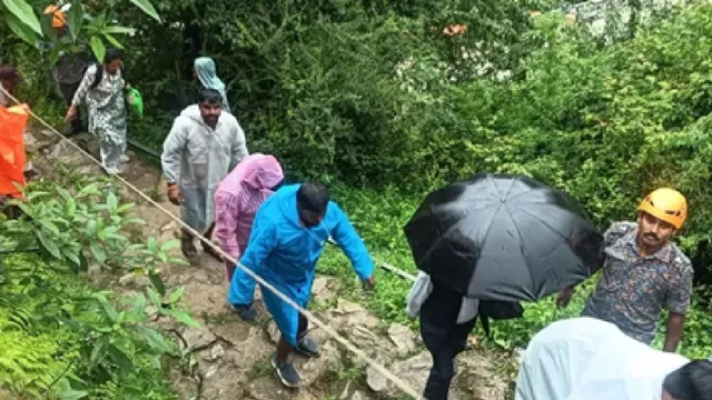 uttarakhand-100-stranded-pilgrims-escorted-to-safety-across-washed-out-stretch-of-yamunotri-national-highway-amid-heavy-rain