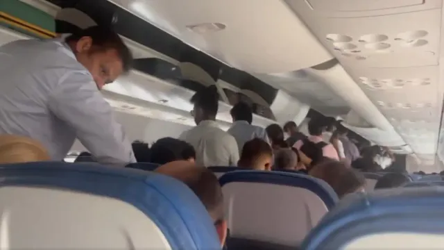 air-india-express-flight-moves-on-runway-while-passengers-standing-in-aisle-of-plane-airline-reacts-after-video-surfaces