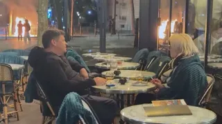 Paris: Couple Casually Sips Coffee, Smokes Cigarettes As Flames Rage Metres Away Amid Violent Protests In France | WATCH
